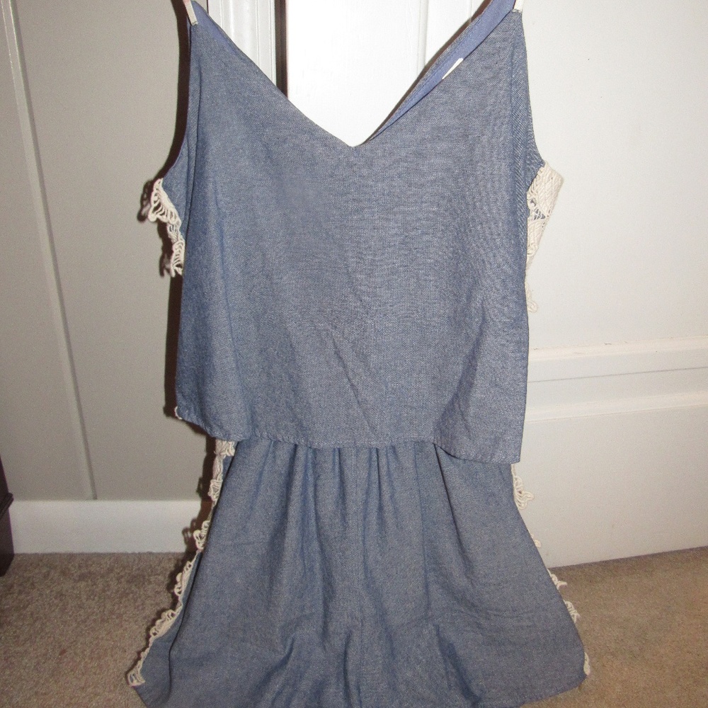 Small summer blue romper with lace on the sides